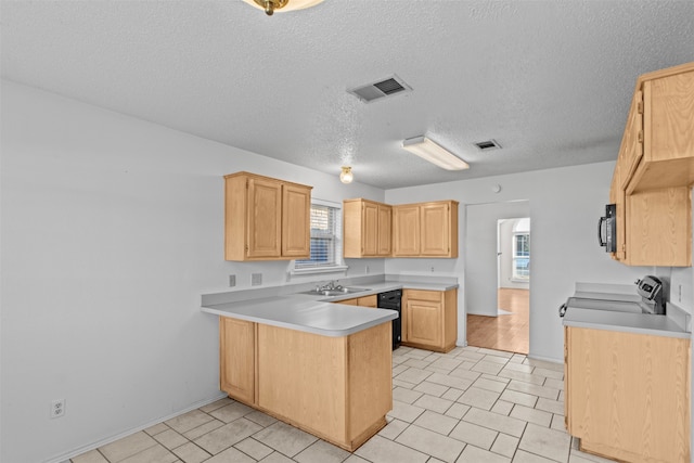 kitchen with kitchen peninsula, a textured ceiling, light brown cabinetry, black appliances, and sink