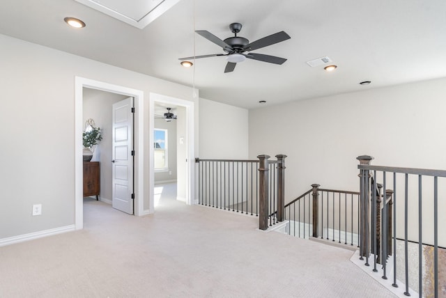 corridor featuring light colored carpet