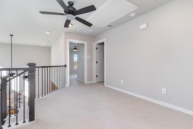 unfurnished room featuring ceiling fan and light carpet