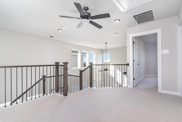 corridor with light colored carpet