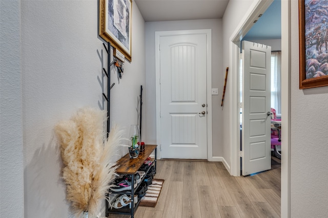 corridor with light hardwood / wood-style flooring