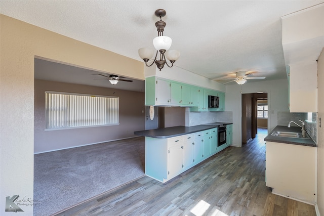 kitchen with tasteful backsplash, black appliances, sink, and dark hardwood / wood-style floors