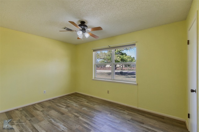 empty room featuring a textured ceiling, hardwood / wood-style flooring, and ceiling fan