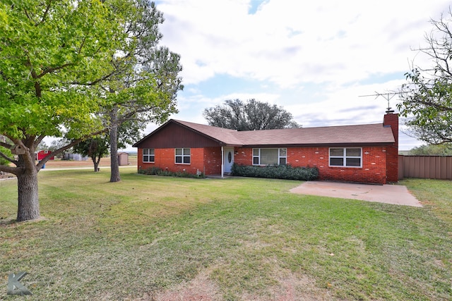 single story home with a front yard and a patio