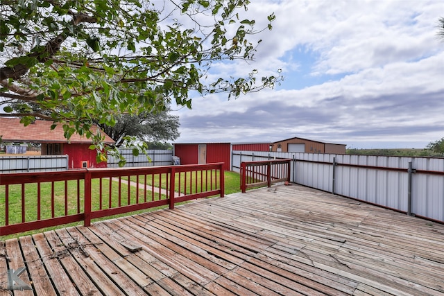 wooden deck featuring a shed and a yard