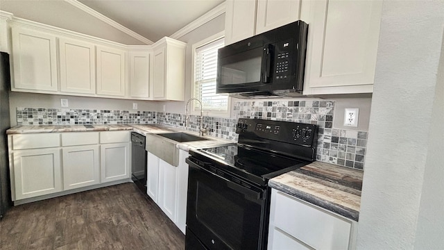 kitchen featuring sink, crown molding, black appliances, white cabinets, and vaulted ceiling