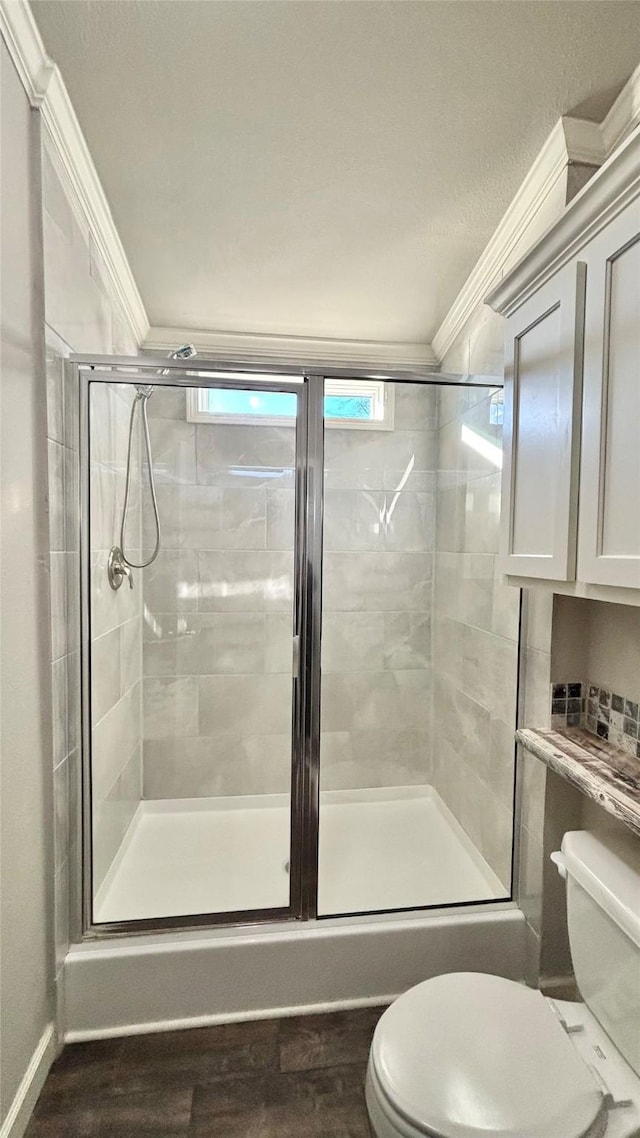 bathroom with an enclosed shower, crown molding, a wealth of natural light, and toilet