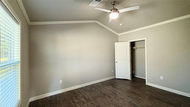 unfurnished bedroom with dark hardwood / wood-style floors, lofted ceiling, ceiling fan, crown molding, and a closet