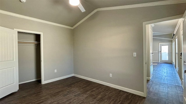 unfurnished bedroom featuring ceiling fan, a closet, crown molding, and vaulted ceiling