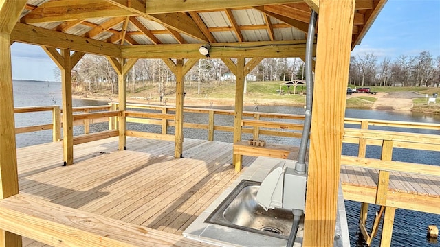 view of dock featuring a gazebo and a deck with water view