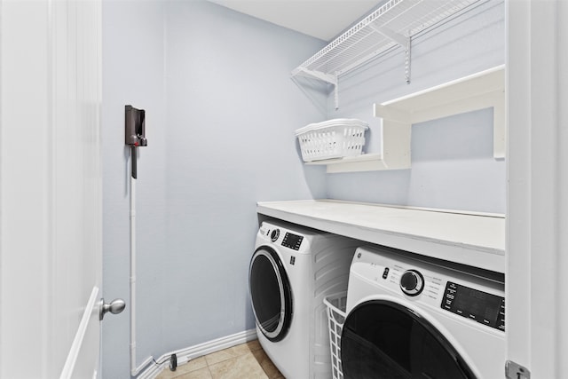 laundry room with independent washer and dryer and light tile patterned floors