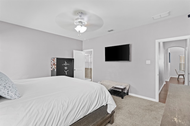 carpeted bedroom featuring ensuite bathroom and ceiling fan