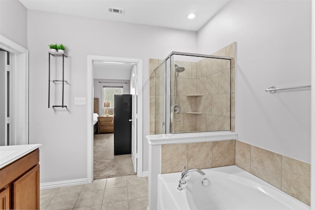 bathroom with vanity, tile patterned floors, and independent shower and bath