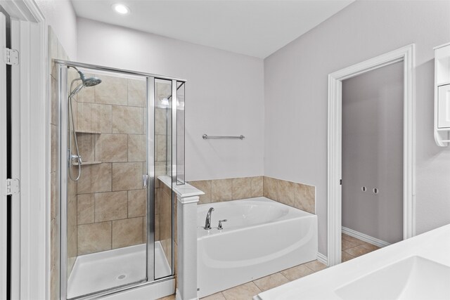 bathroom with tile patterned floors and separate shower and tub