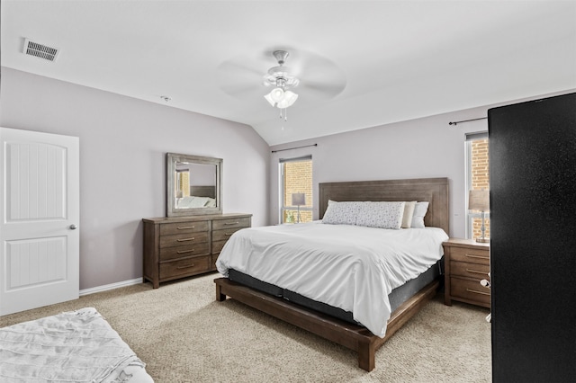 carpeted bedroom with vaulted ceiling, multiple windows, and ceiling fan