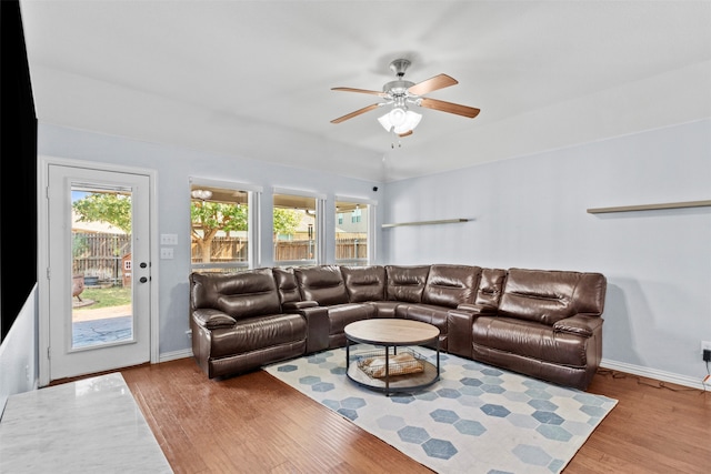 living room with light hardwood / wood-style floors and ceiling fan