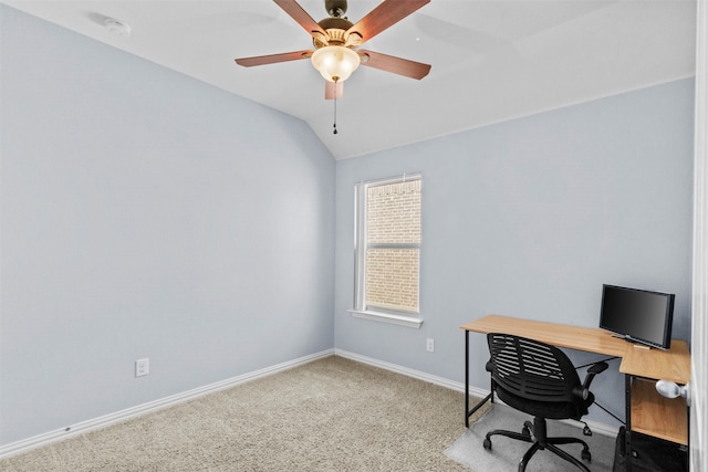 carpeted home office featuring lofted ceiling and ceiling fan