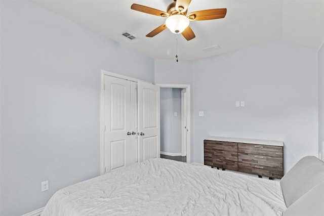 bedroom with lofted ceiling, a closet, and ceiling fan