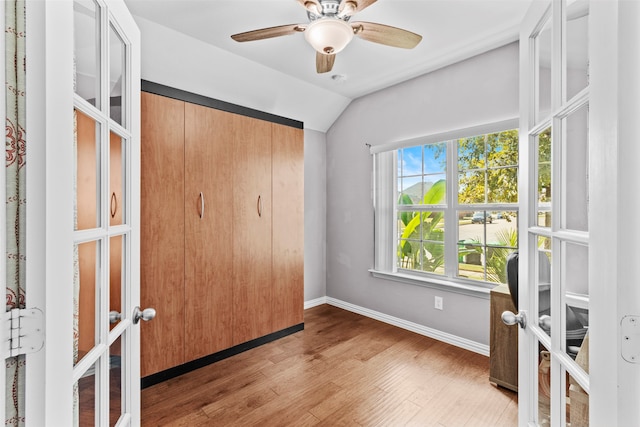 unfurnished bedroom with lofted ceiling, french doors, light hardwood / wood-style floors, and ceiling fan