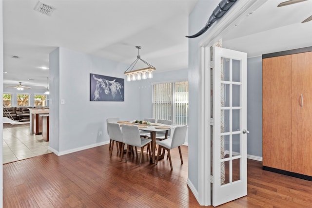 dining area with hardwood / wood-style floors and ceiling fan