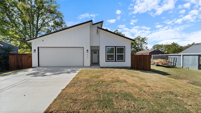 view of front of house with a front lawn and a garage