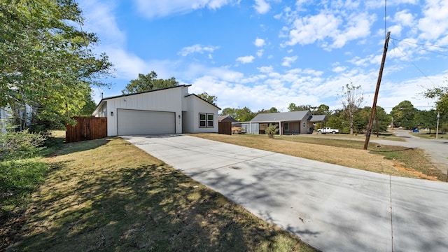 view of front of property featuring a front yard and a garage