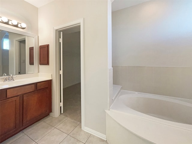 bathroom featuring vanity, tile patterned flooring, and a bathing tub