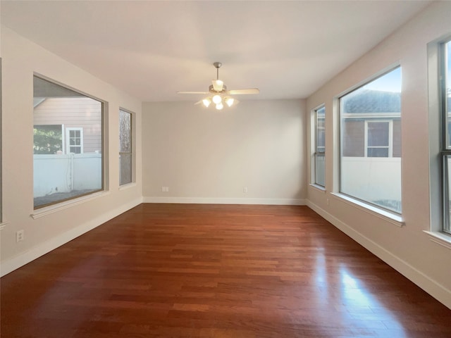 unfurnished room with ceiling fan, dark hardwood / wood-style floors, and plenty of natural light