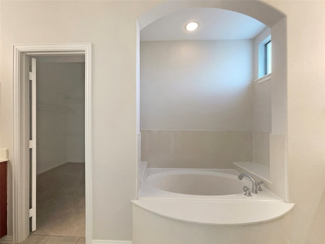 bathroom with vanity, a bathtub, and tile patterned flooring