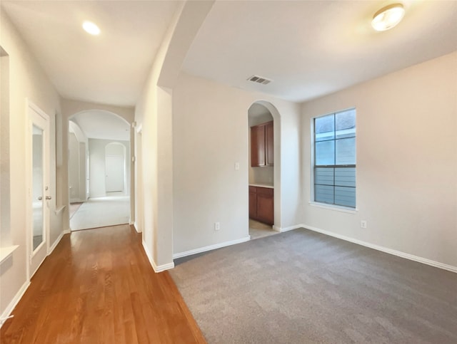 spare room with dark hardwood / wood-style floors