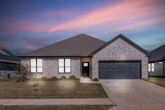 view of front of property featuring central AC and a garage