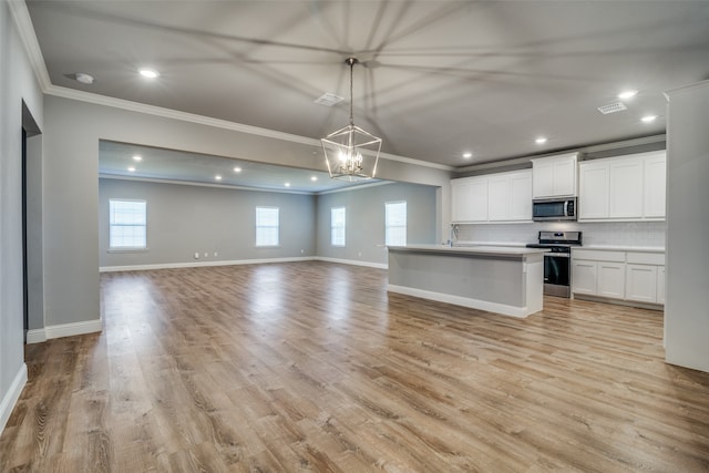 kitchen with crown molding, white cabinets, decorative light fixtures, appliances with stainless steel finishes, and light hardwood / wood-style floors