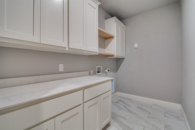 laundry area with cabinets, hookup for a washing machine, and hookup for an electric dryer