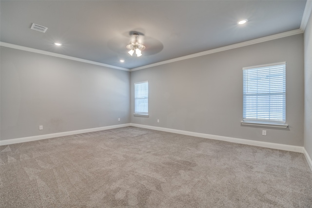 carpeted empty room featuring crown molding, a healthy amount of sunlight, and ceiling fan