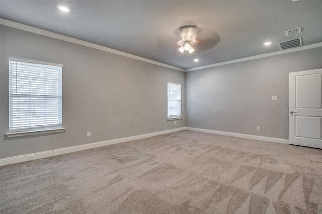 unfurnished room featuring crown molding, light colored carpet, and ceiling fan