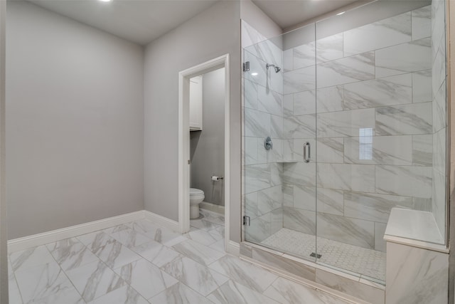 bathroom with a shower with shower door and toilet