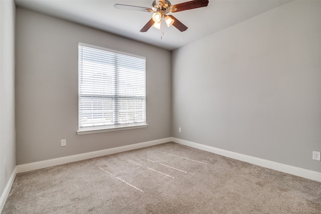 unfurnished room with light colored carpet and ceiling fan