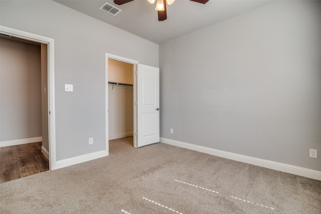 unfurnished bedroom featuring a closet, carpet floors, and ceiling fan