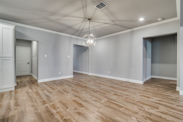 empty room with ornamental molding and light hardwood / wood-style flooring