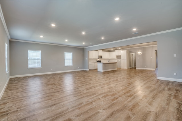 unfurnished living room with crown molding and light wood-type flooring