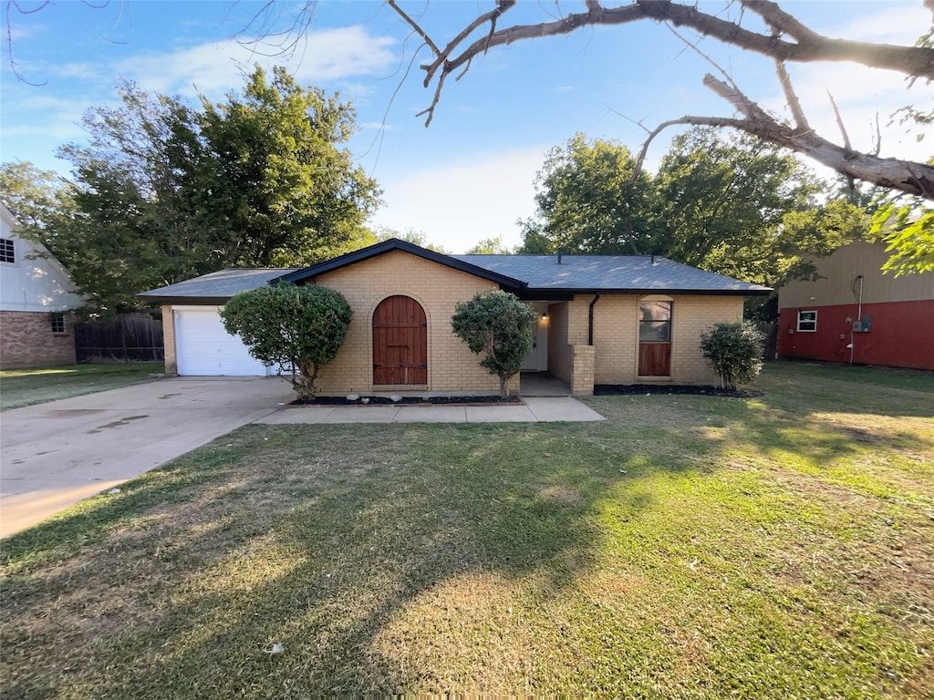 single story home with a front yard and a garage