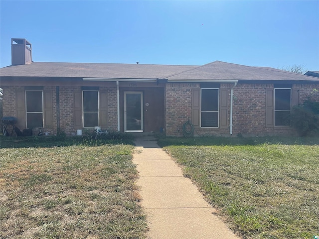 1326 Greenbriar Ln, Lancaster, TX 75146 - ranch-style house featuring brick siding, a chimney, a front lawn, and a shingled roof