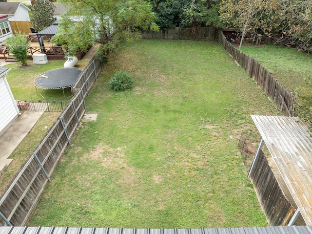 view of yard with a fenced backyard, a trampoline, and a gazebo