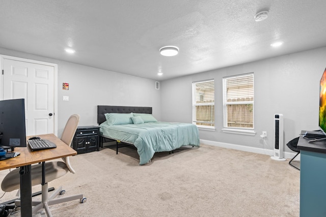 bedroom with baseboards, light carpet, recessed lighting, and a textured ceiling