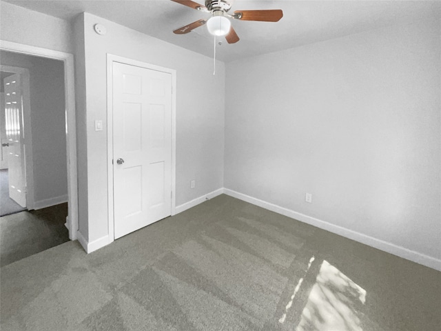 unfurnished bedroom featuring a closet, ceiling fan, and dark colored carpet