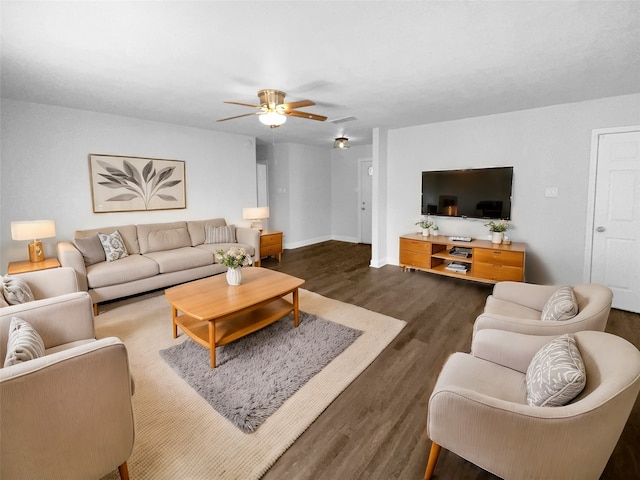 living room featuring ceiling fan and dark hardwood / wood-style flooring