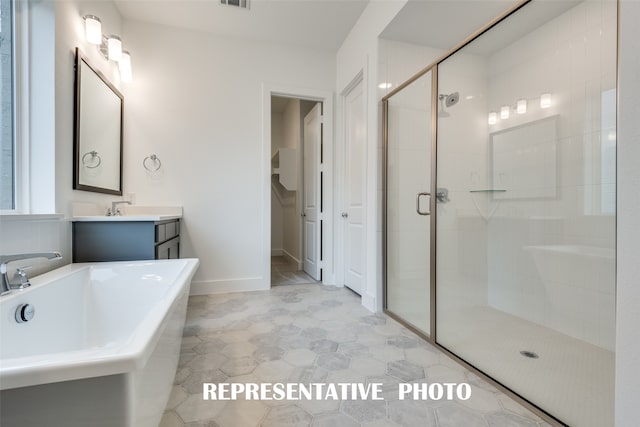 bathroom featuring vanity, independent shower and bath, and tile patterned flooring