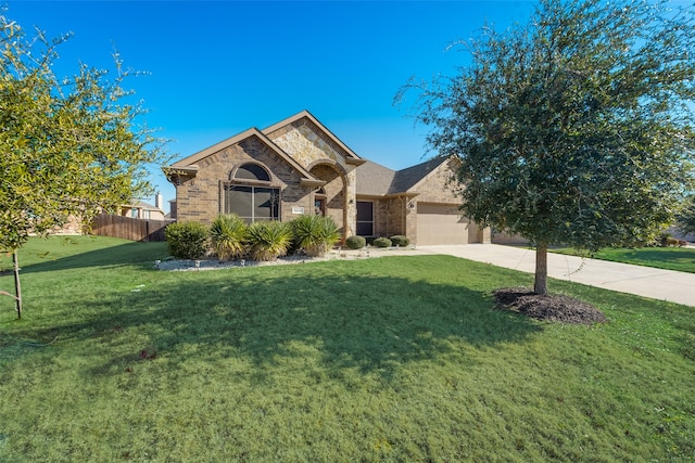 view of front of property featuring a front lawn and a garage