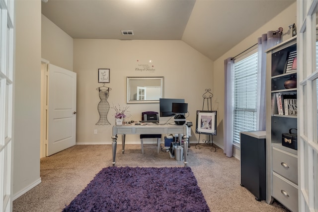 home office with light carpet and vaulted ceiling