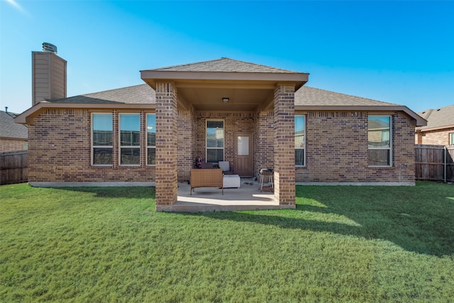 back of house featuring a yard and a patio